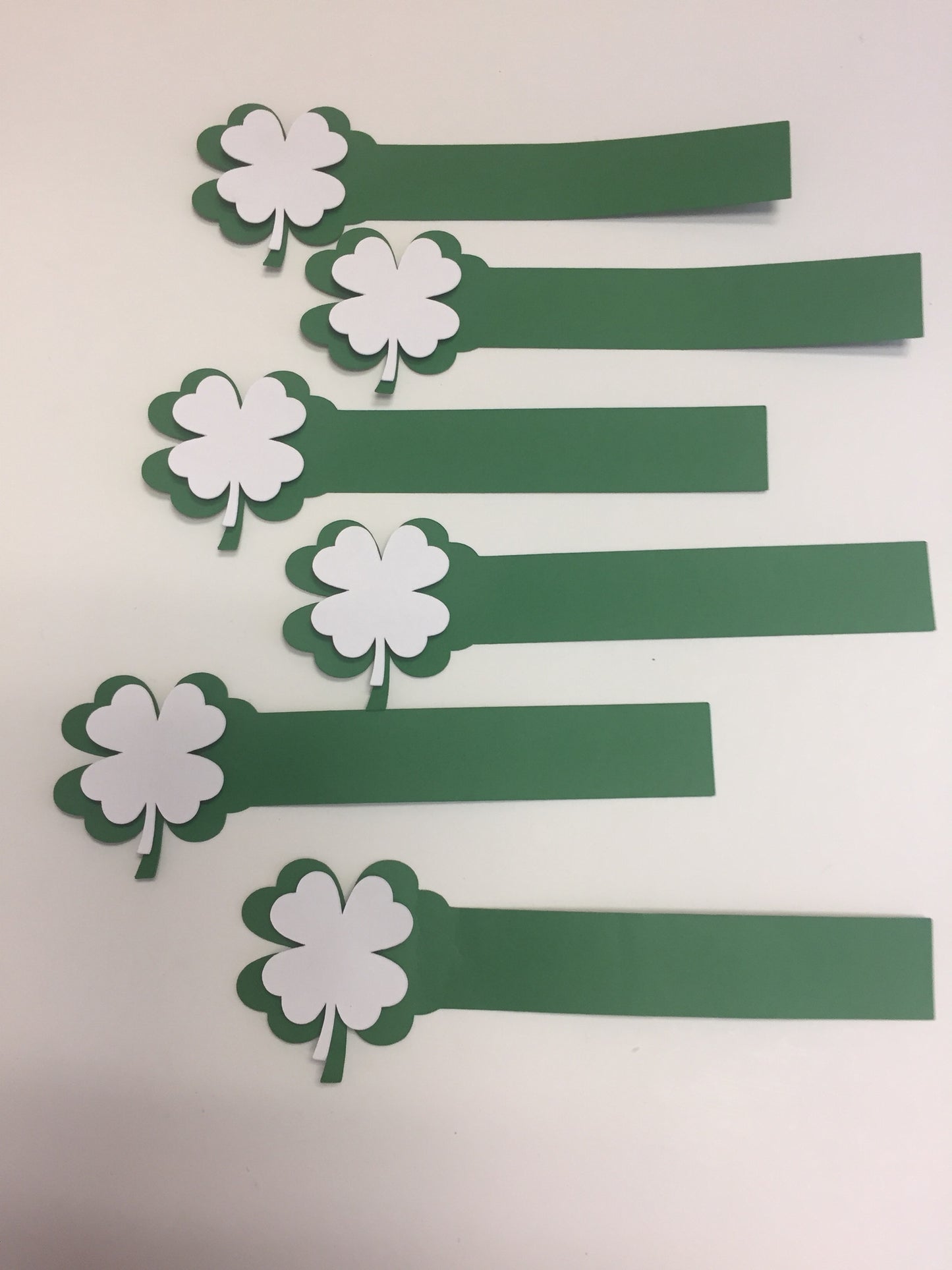 Grren Heavy Duty Paper Shamrock 4 leaf clover napkin rings with raised white Shamrock.